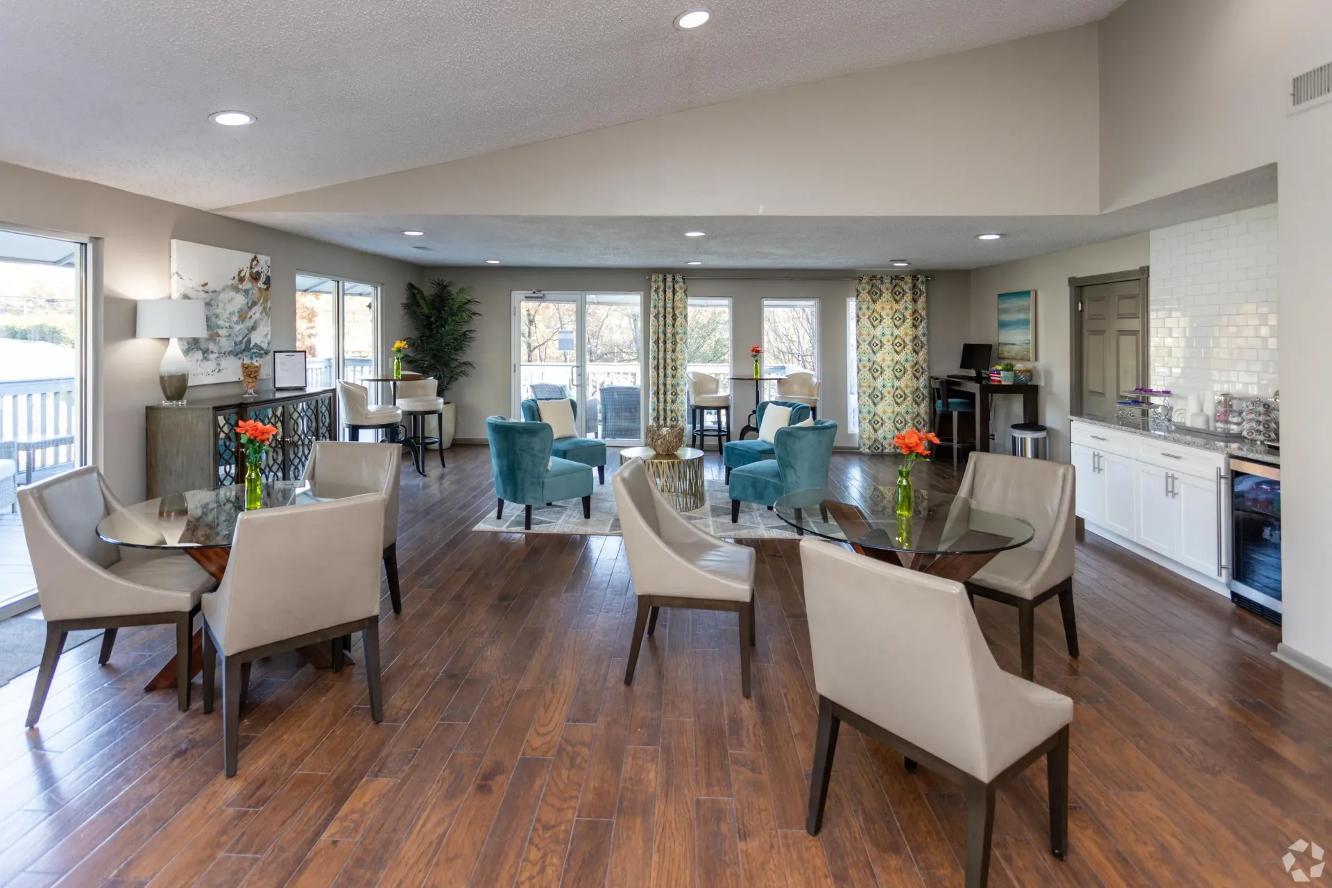 Modern clubhouse with many chairs and tables in the room in West Knoxville, TN apartment
