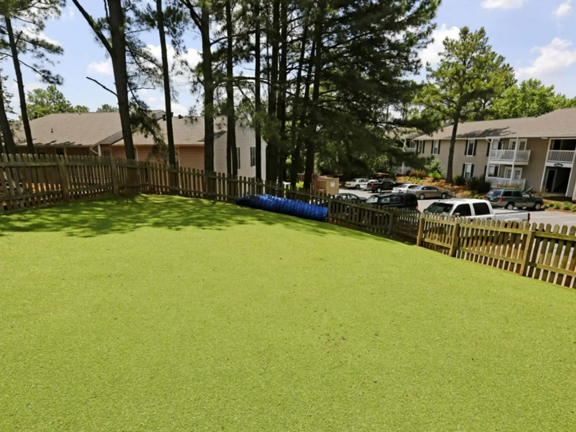 A large grassy area with a wooden fence surrounding it in West Knoxville, TN