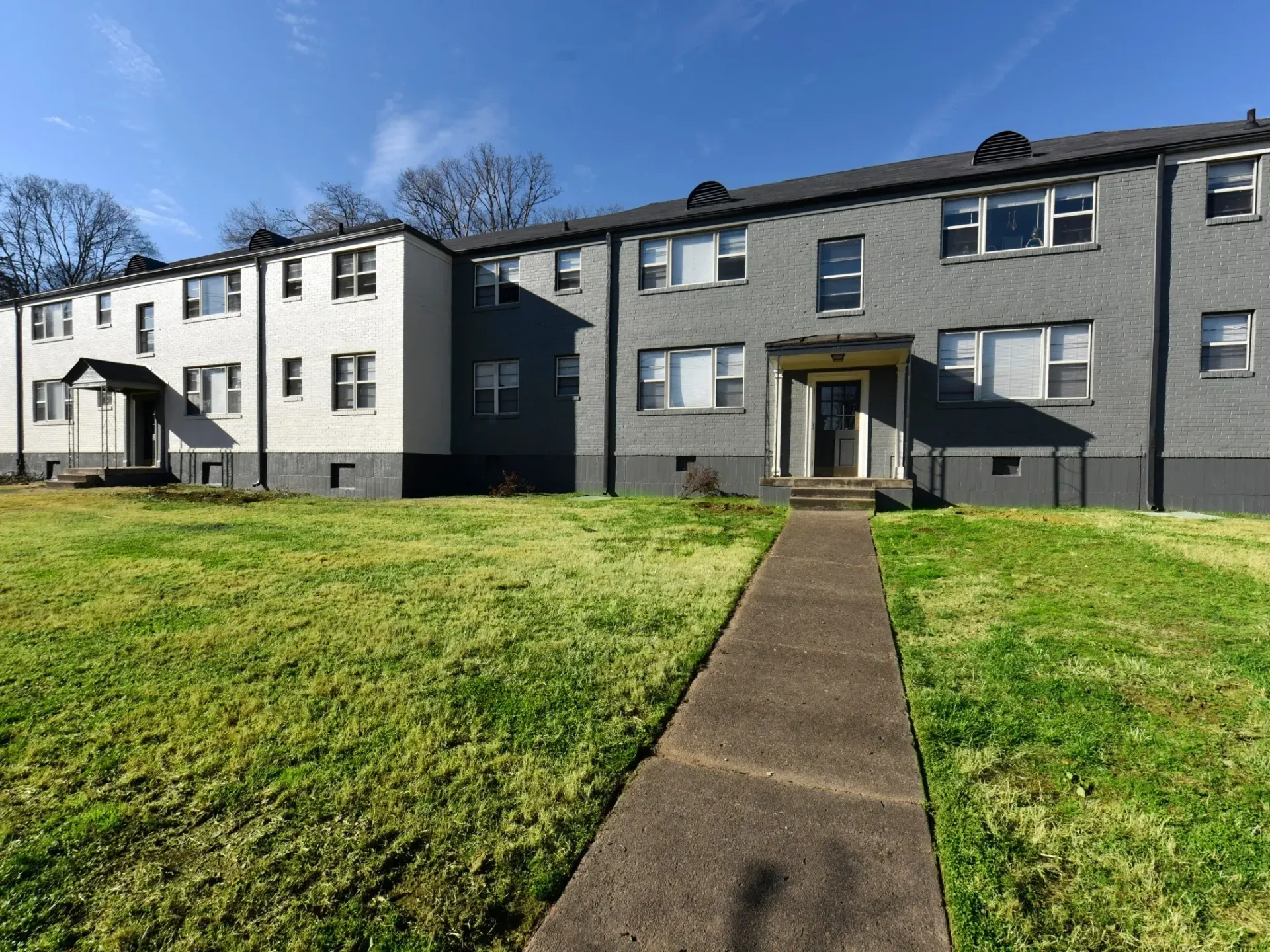 A large apartment building with a walkway leading to it. Emerson Apartments, Knoxville, TN
