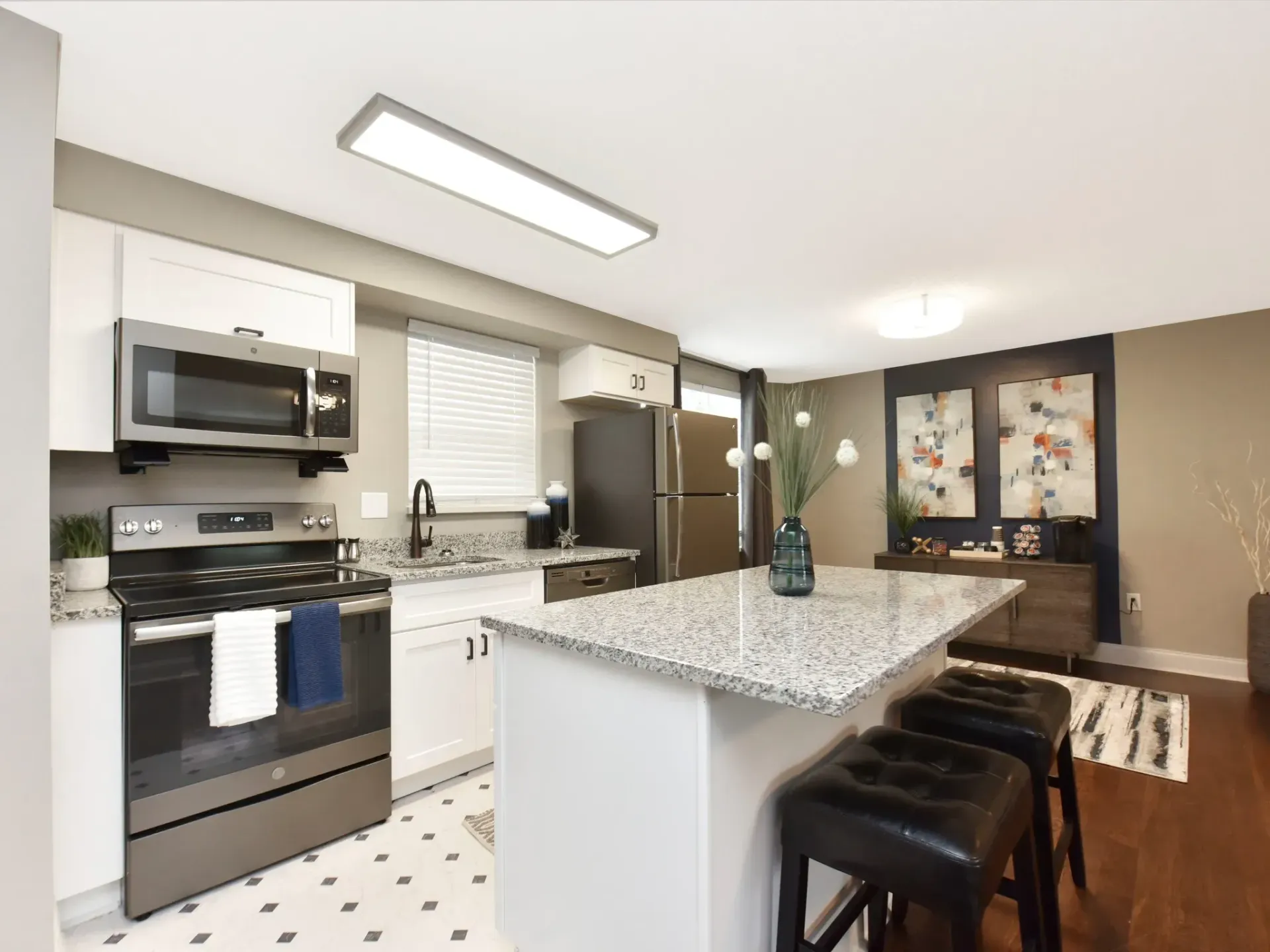 A kitchen with stainless steel appliances and granite counter tops