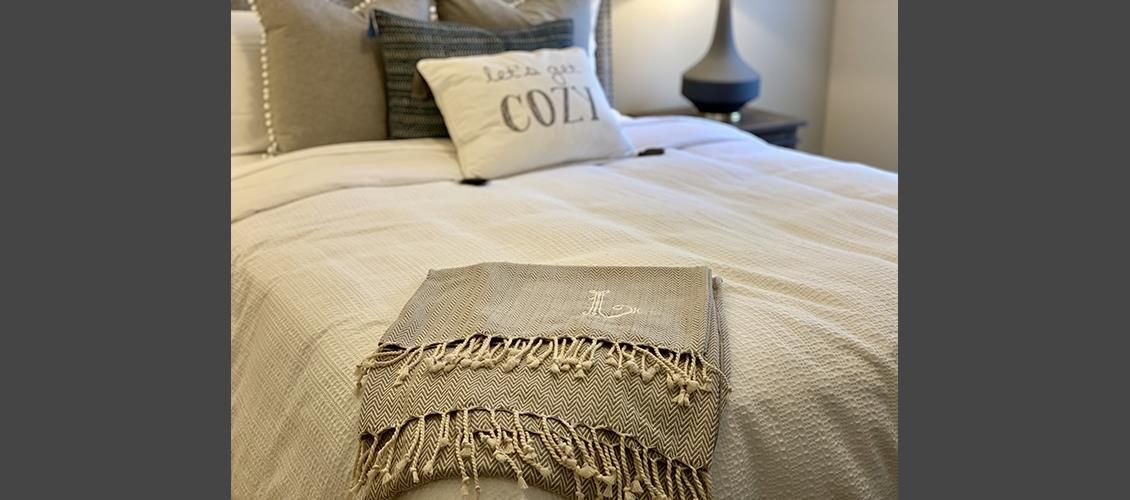 A bed with a blanket and a pillow on it.