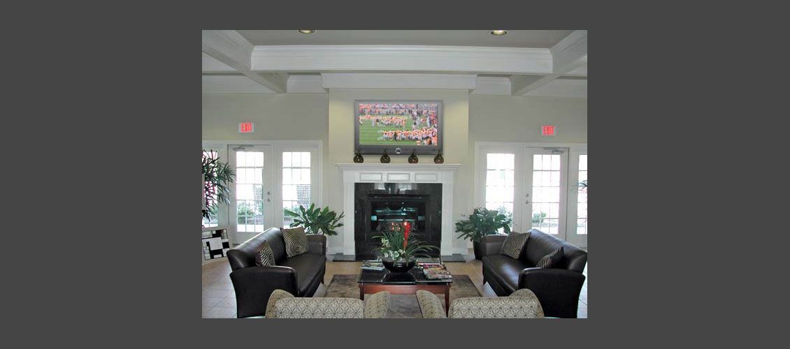 A living room with a fireplace and a flat screen tv