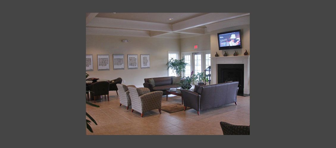 A living room with a fireplace and a flat screen tv