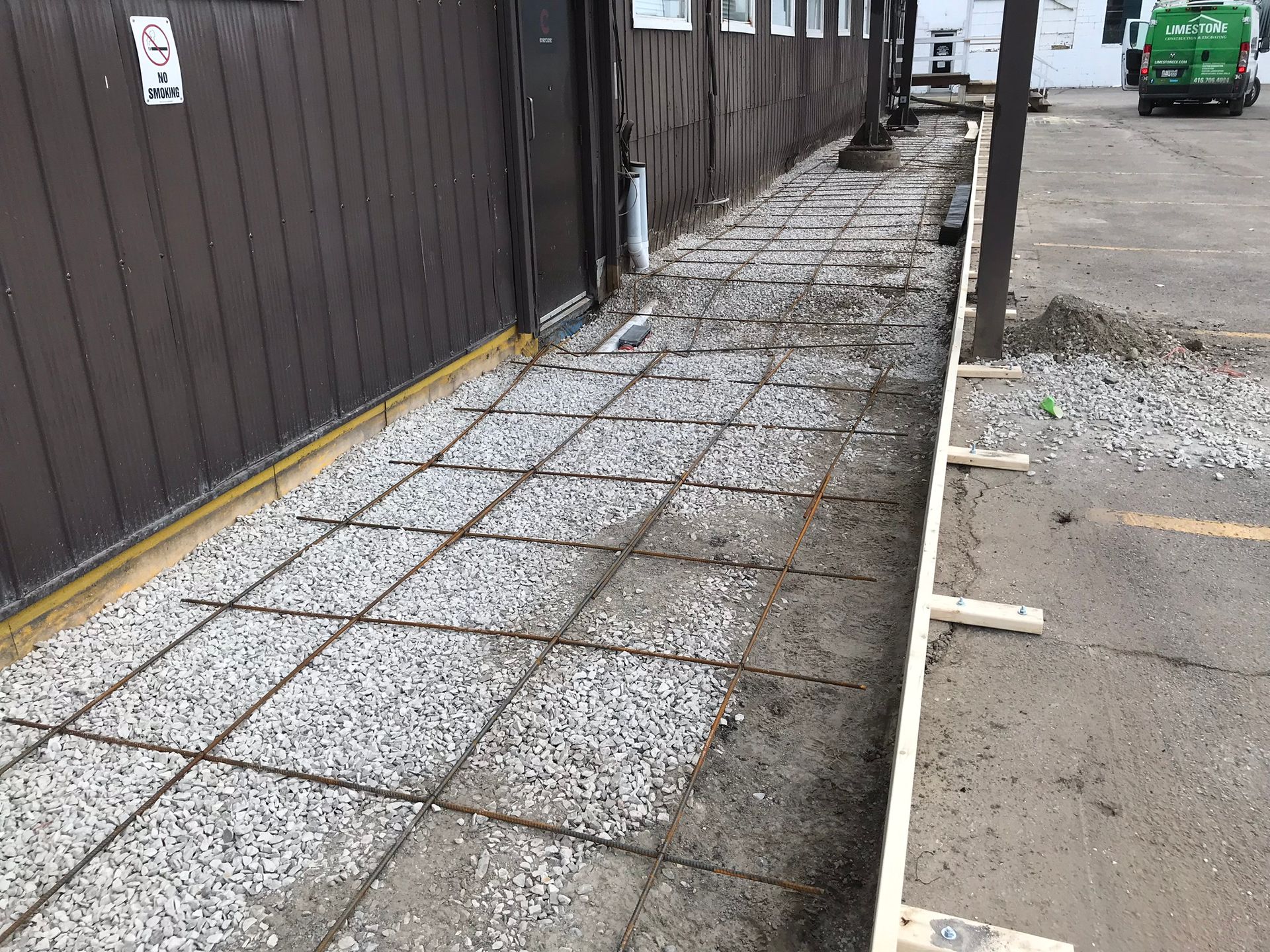 a sidewalk is being built in front of a building .