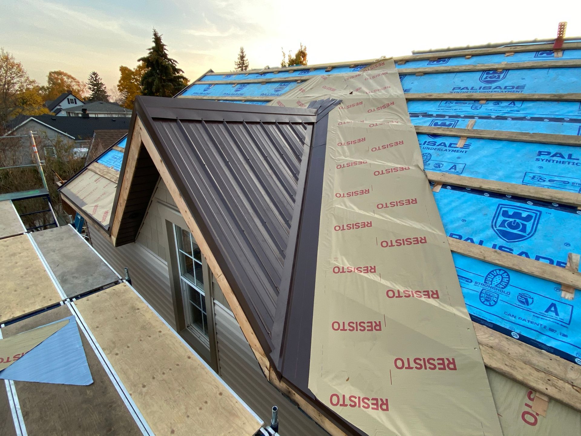 a roof is being installed on a house with a metal roof .