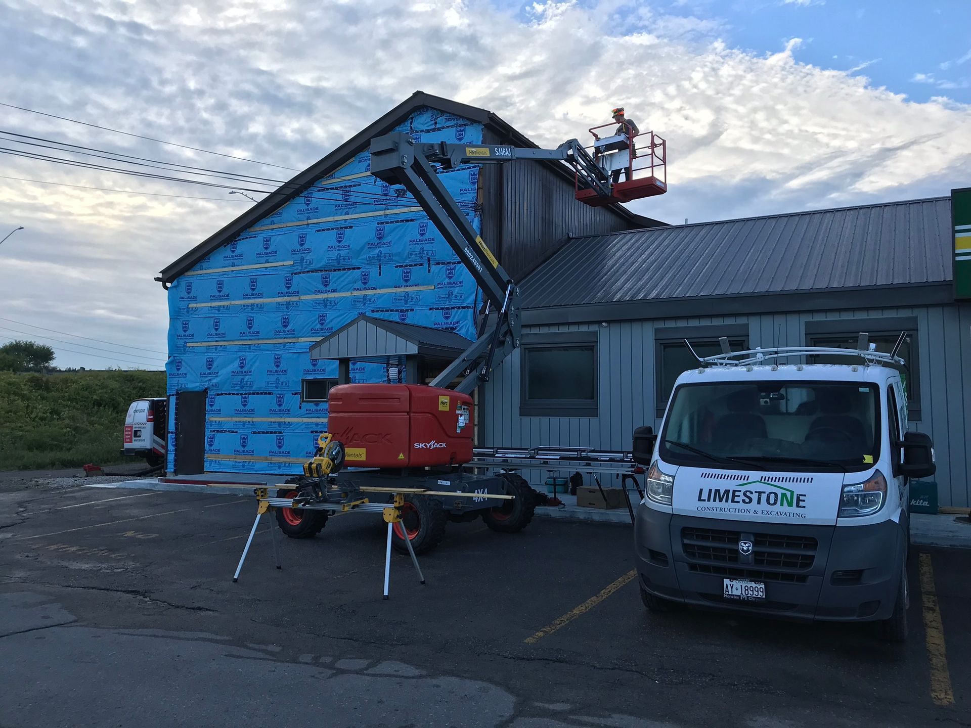 a construction vehicle is parked in front of a building .