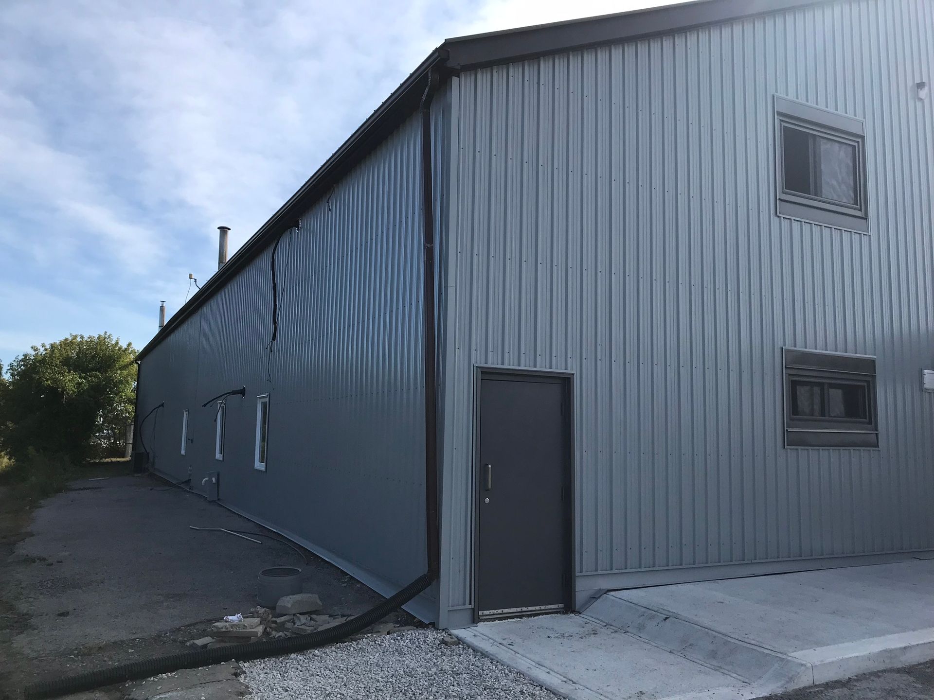 a large gray building with a black door and windows
