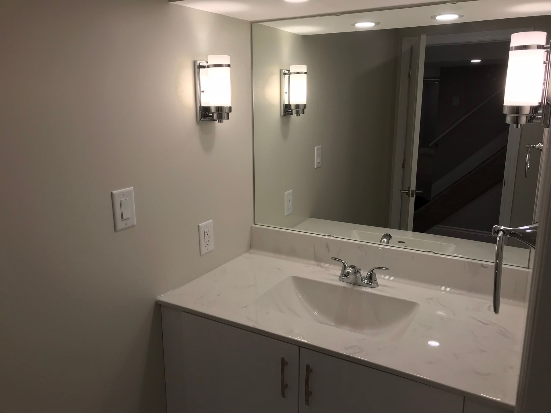 a bathroom with a sink and a large mirror .