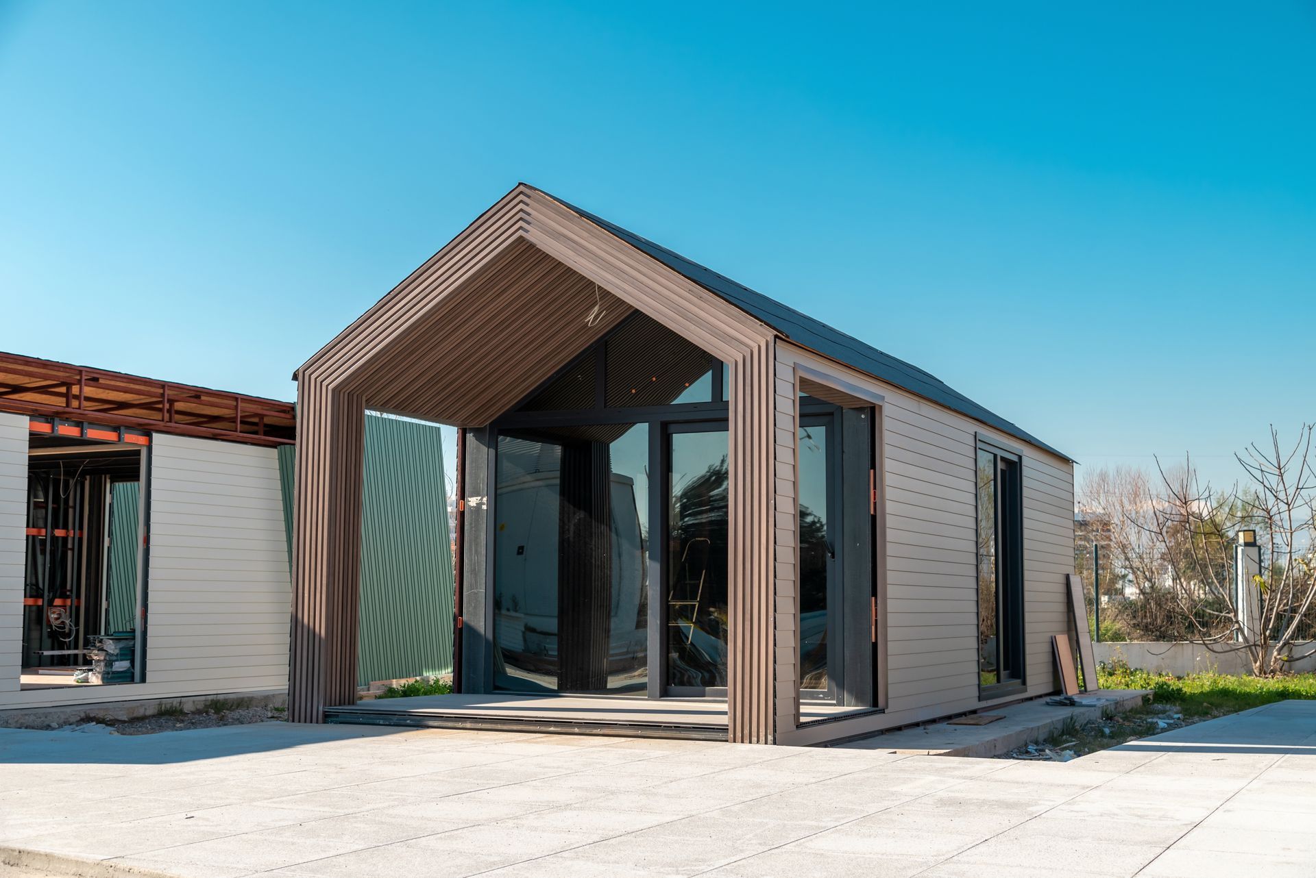a small structure with a roof and a lot of windows is being built 