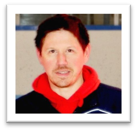 Portrait of a person in a red hooded sweatshirt and dark jacket, facing forward with a neutral expression