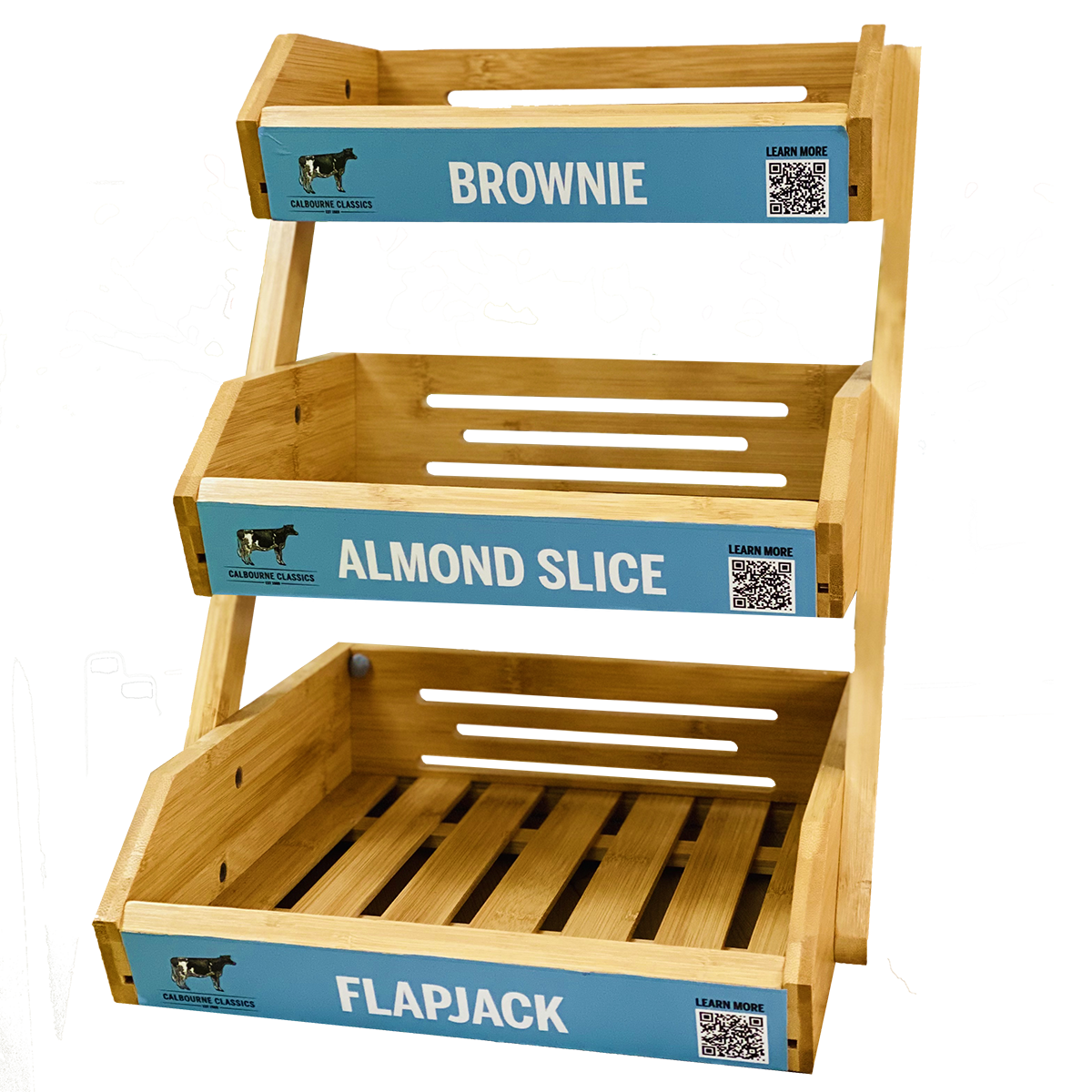 Wooden tiered display shelf with brownies, almond slices, and flapjacks labels.