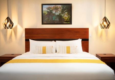 There is a picture on the wall above the bed.