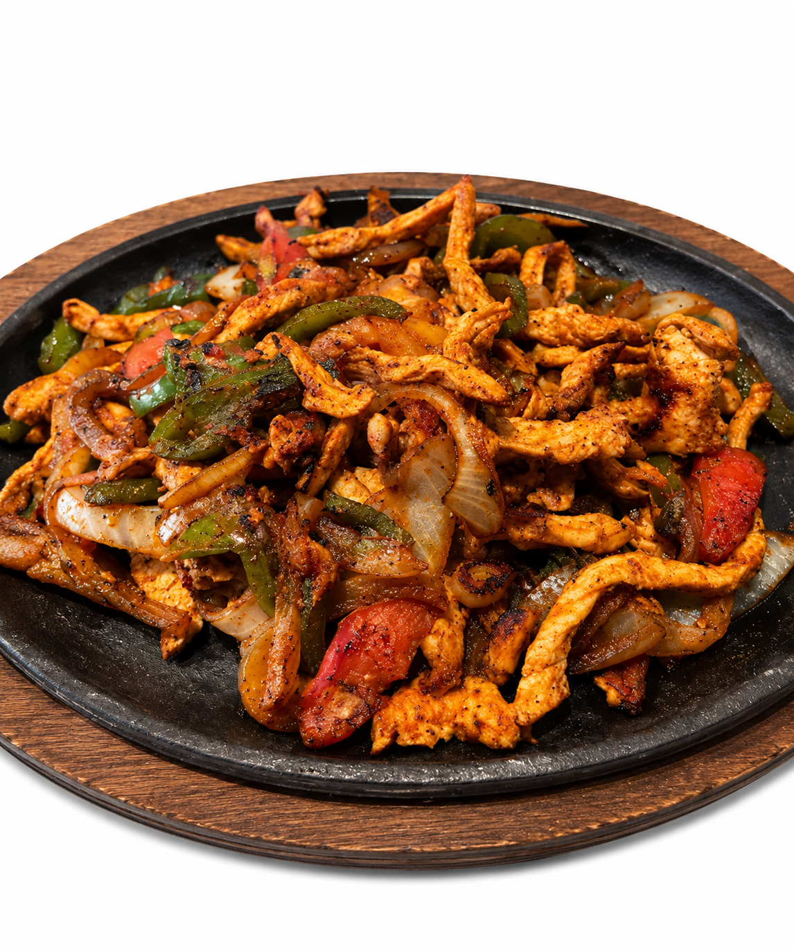 Grilled steak and chicken fajita platter with guacamole, sour cream, peppers, and tortillas on a wooden board