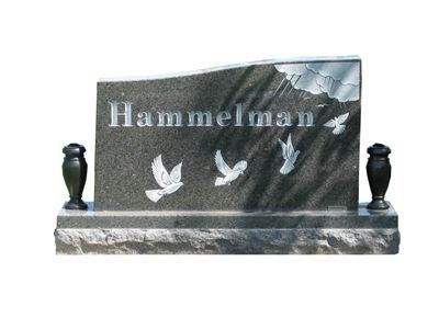 curved headstone with vases