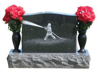 curved headstone with vases and firefighter display