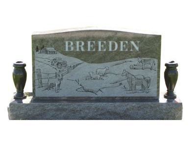 curved headstone with vases