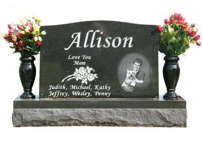curved headstone with vases