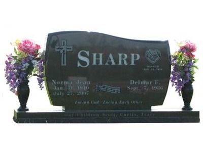 curved headstone with vases