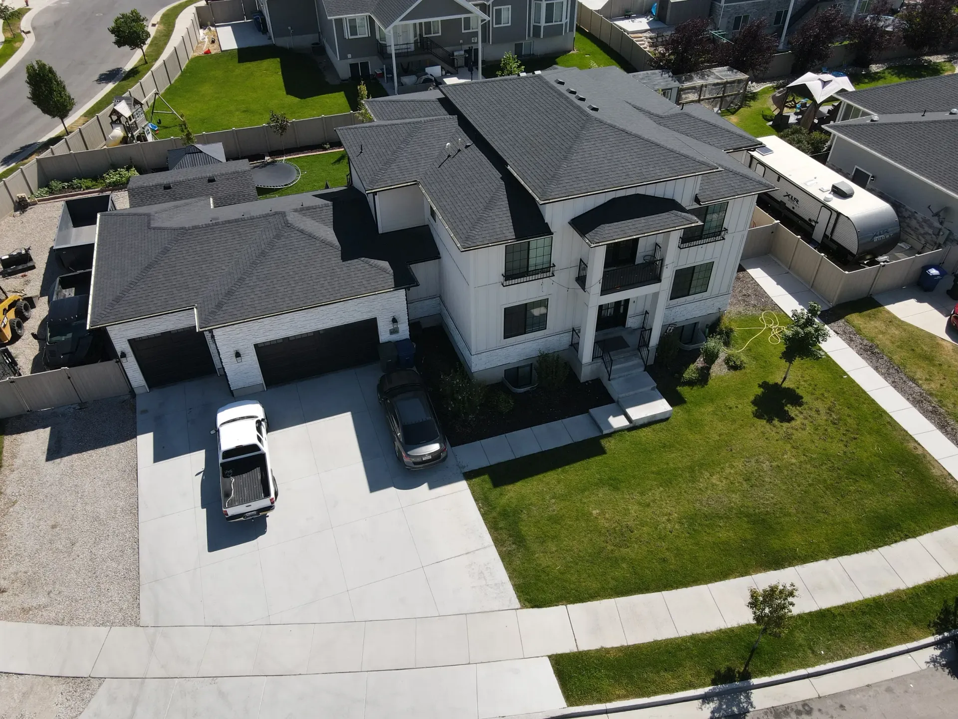 An aerial view of a large house with a truck parked in front of it