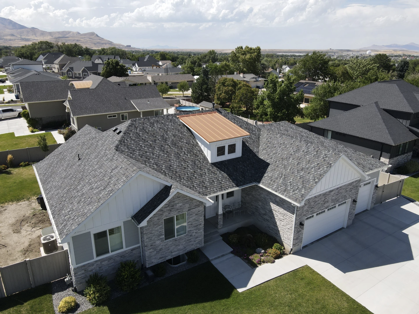 An aerial view of a house with a black roof