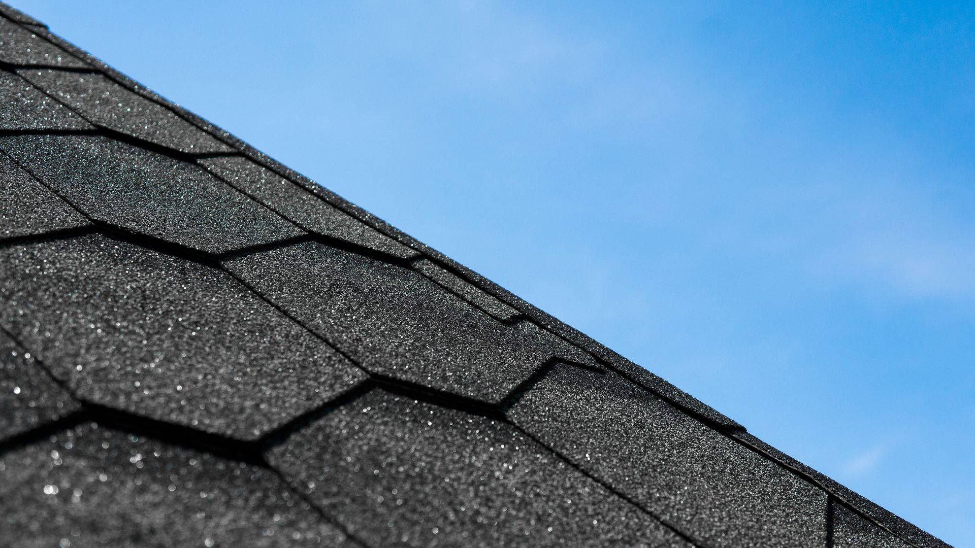 A close up of a roof with a blue sky in the background.