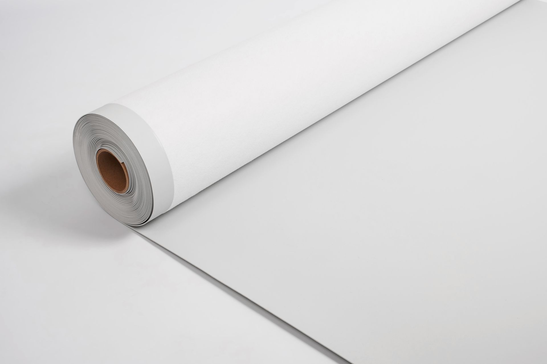 A roll of white paper is sitting on a white surface.