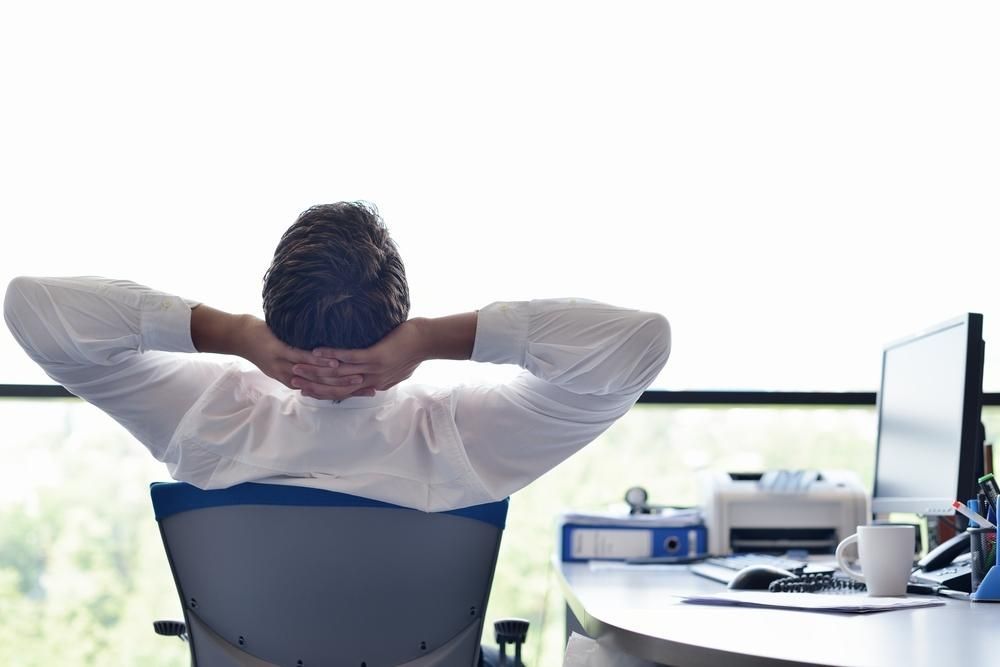A Man Is Sitting In An Office Chair — Lake Macquarie Counselling & Psychotherapy In Lake Macquarie, NSW