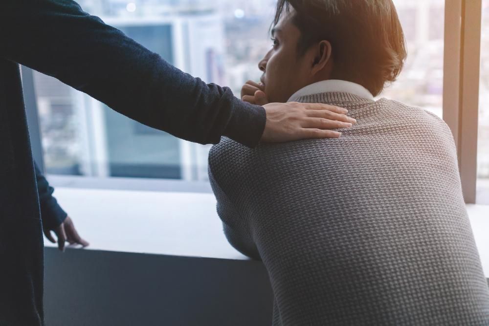 A Man Is Being Comforted By Another Man — Lake Macquarie Counselling & Psychotherapy In Toronto, NSW