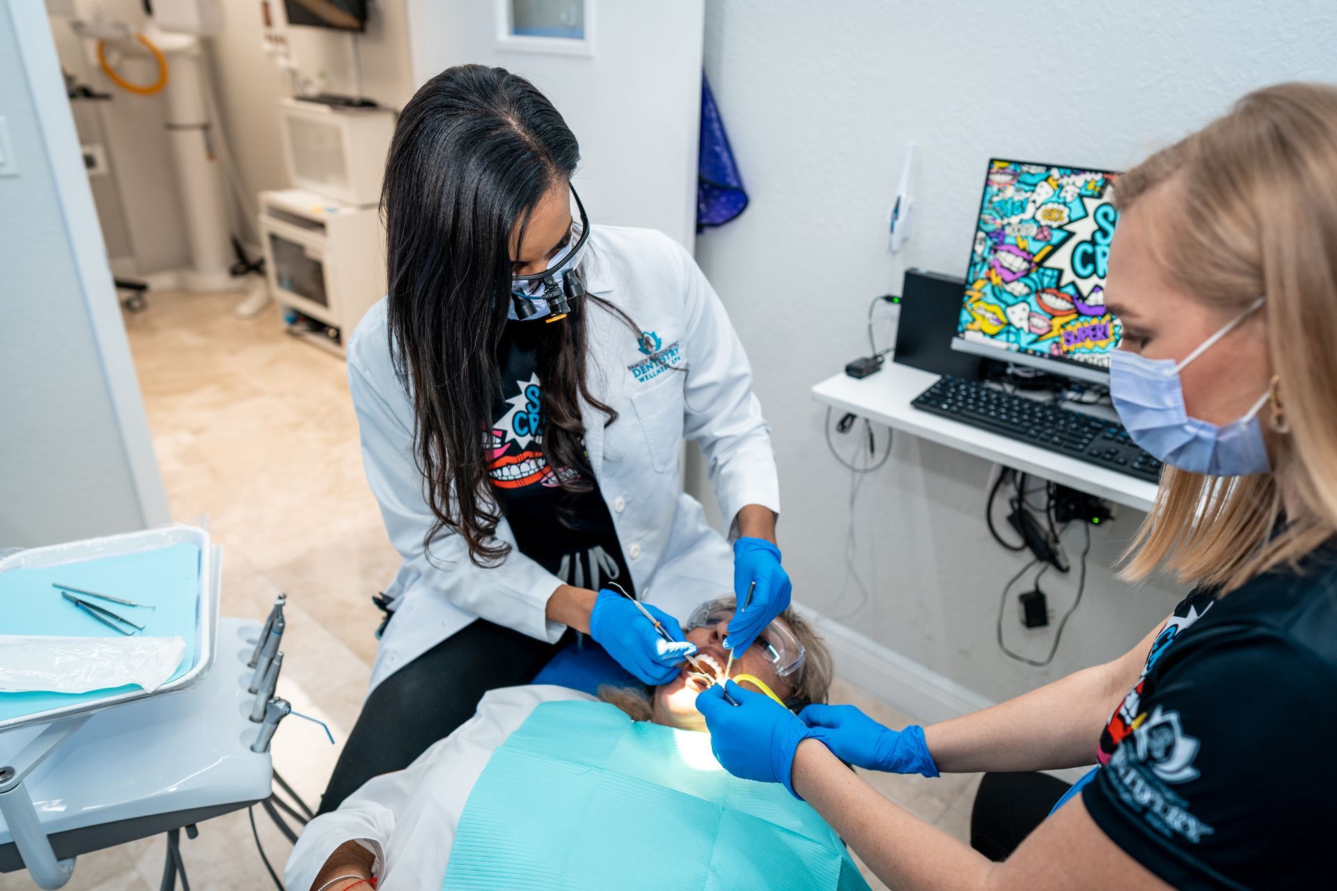 A dentist is examining a patient 's teeth in a dental office.