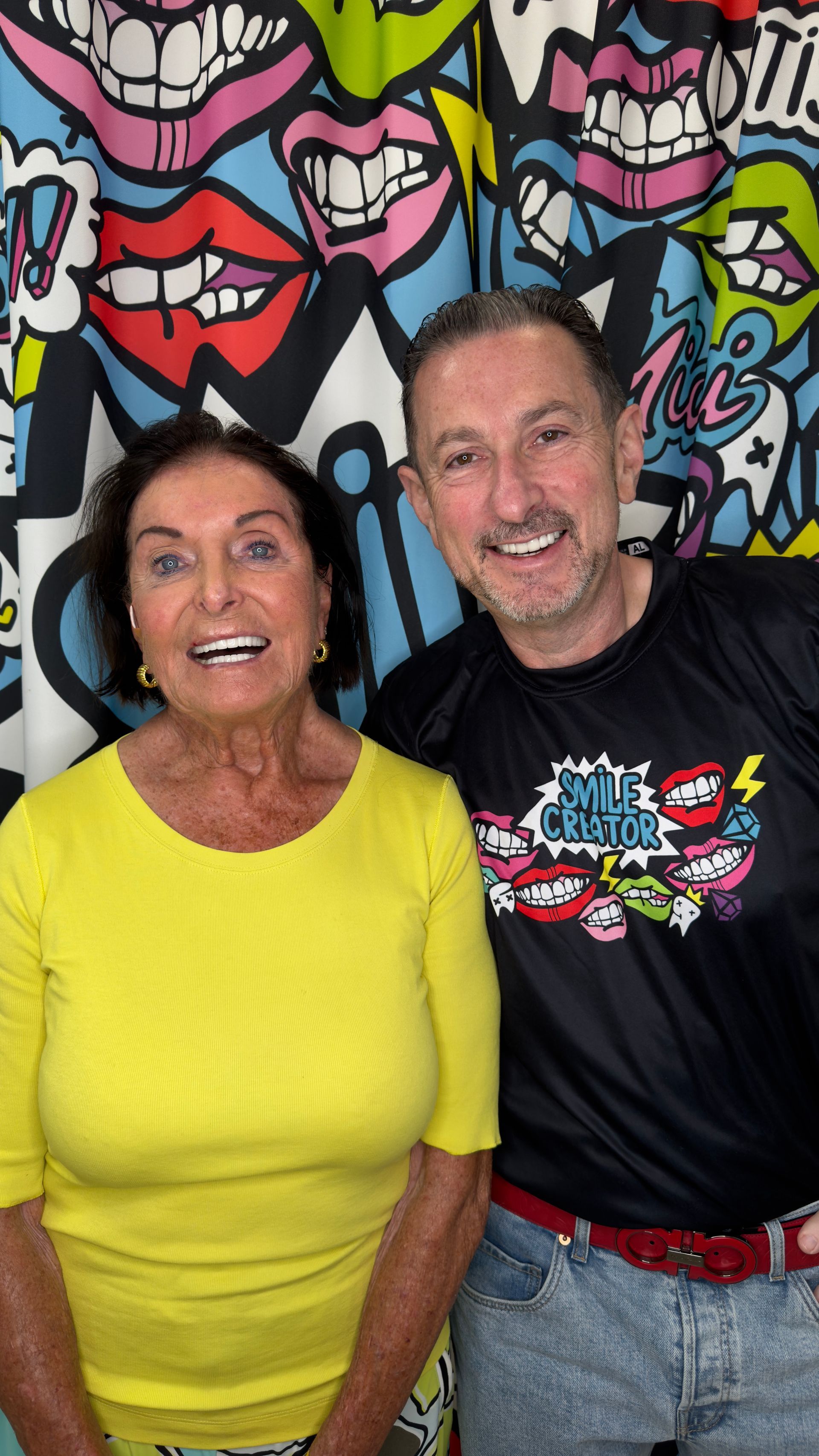 An older woman with gray hair is smiling for the camera