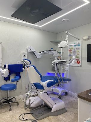 A dental office with a blue and white dental chair.