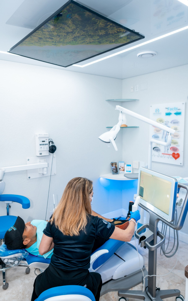 A woman is sitting at a table talking to a doctor.