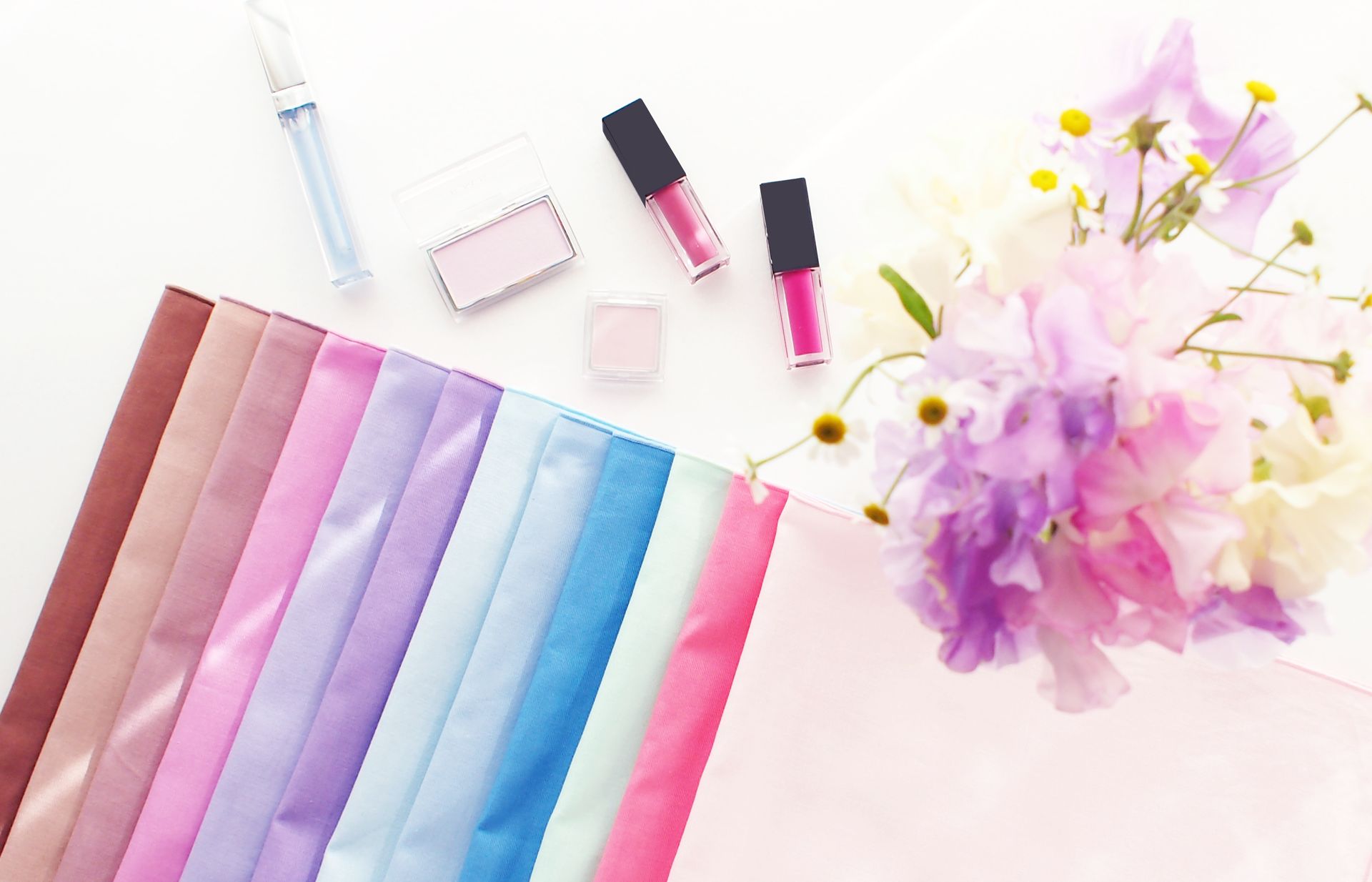 Draping fabric and makeup in seasonal colors for personal color analysis.