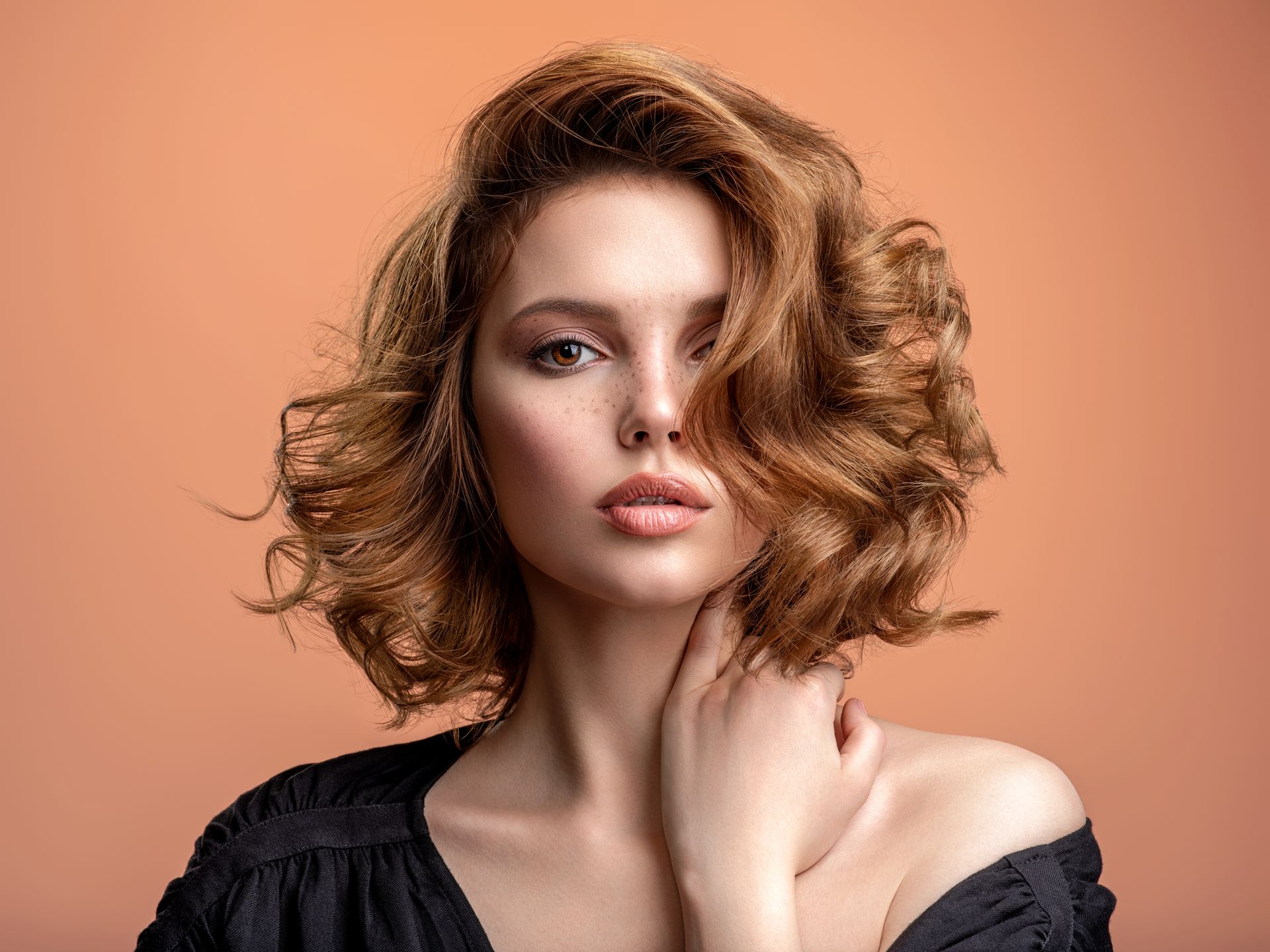 Young woman with stylish wavy hair 