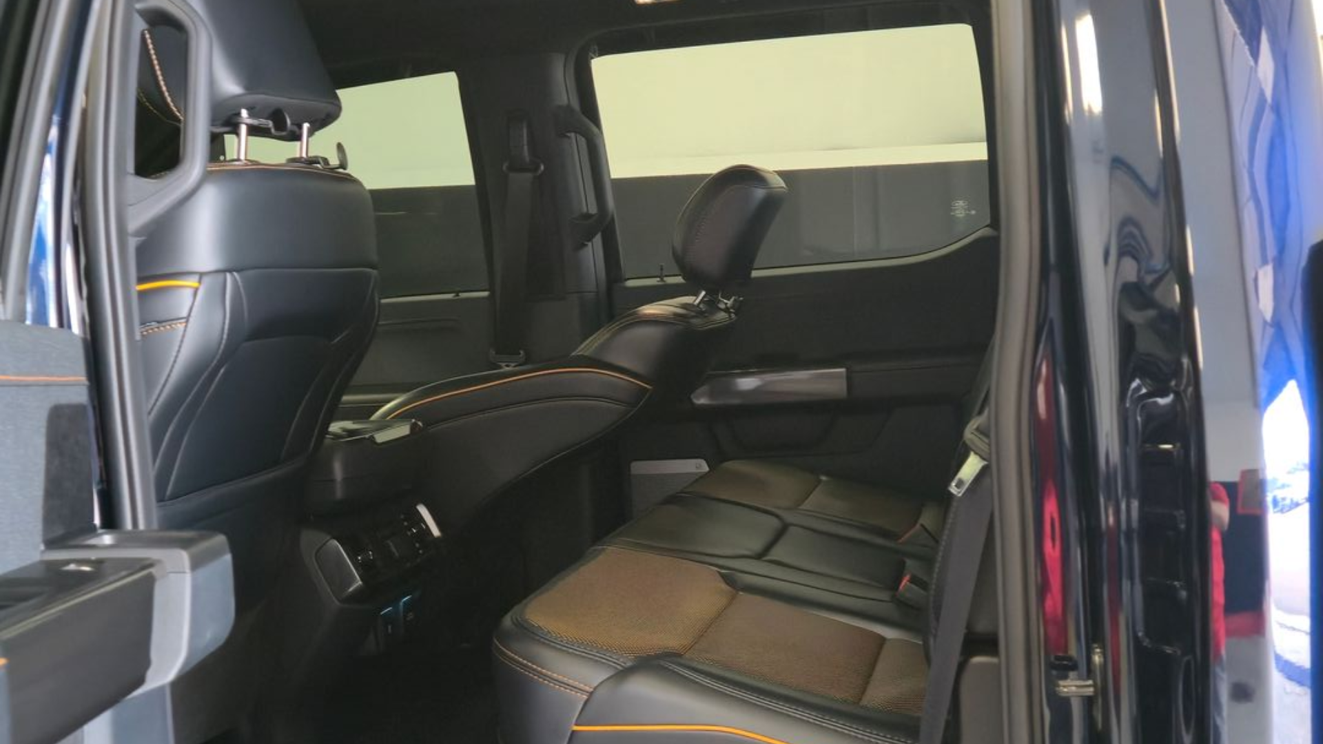 Black car interior with folded seats.