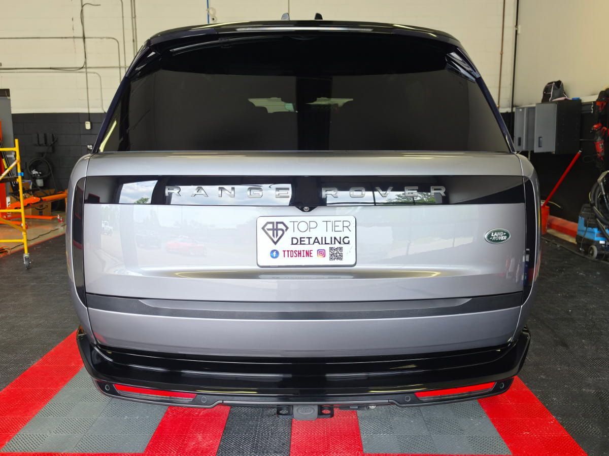 Rear view of a silver Range Rover inside the Top Tier Detailing shop.