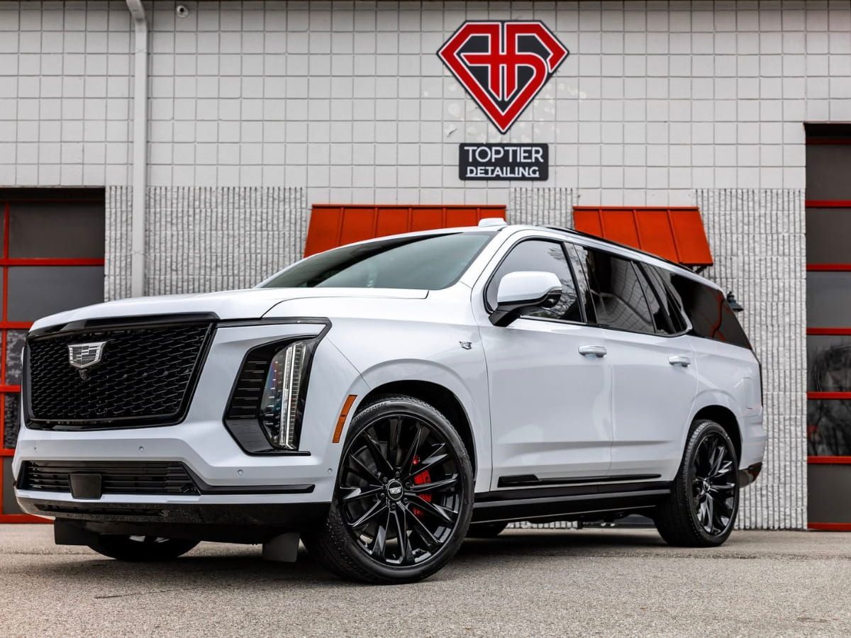 White Cadillac Escalade-V parked outside Top Tier Detailing.