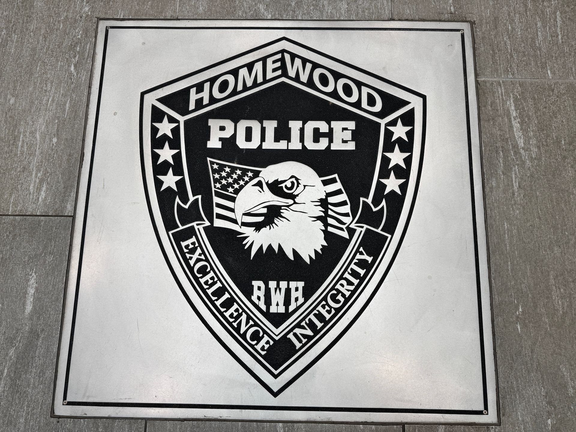 A black and white emblem for the homewood police
