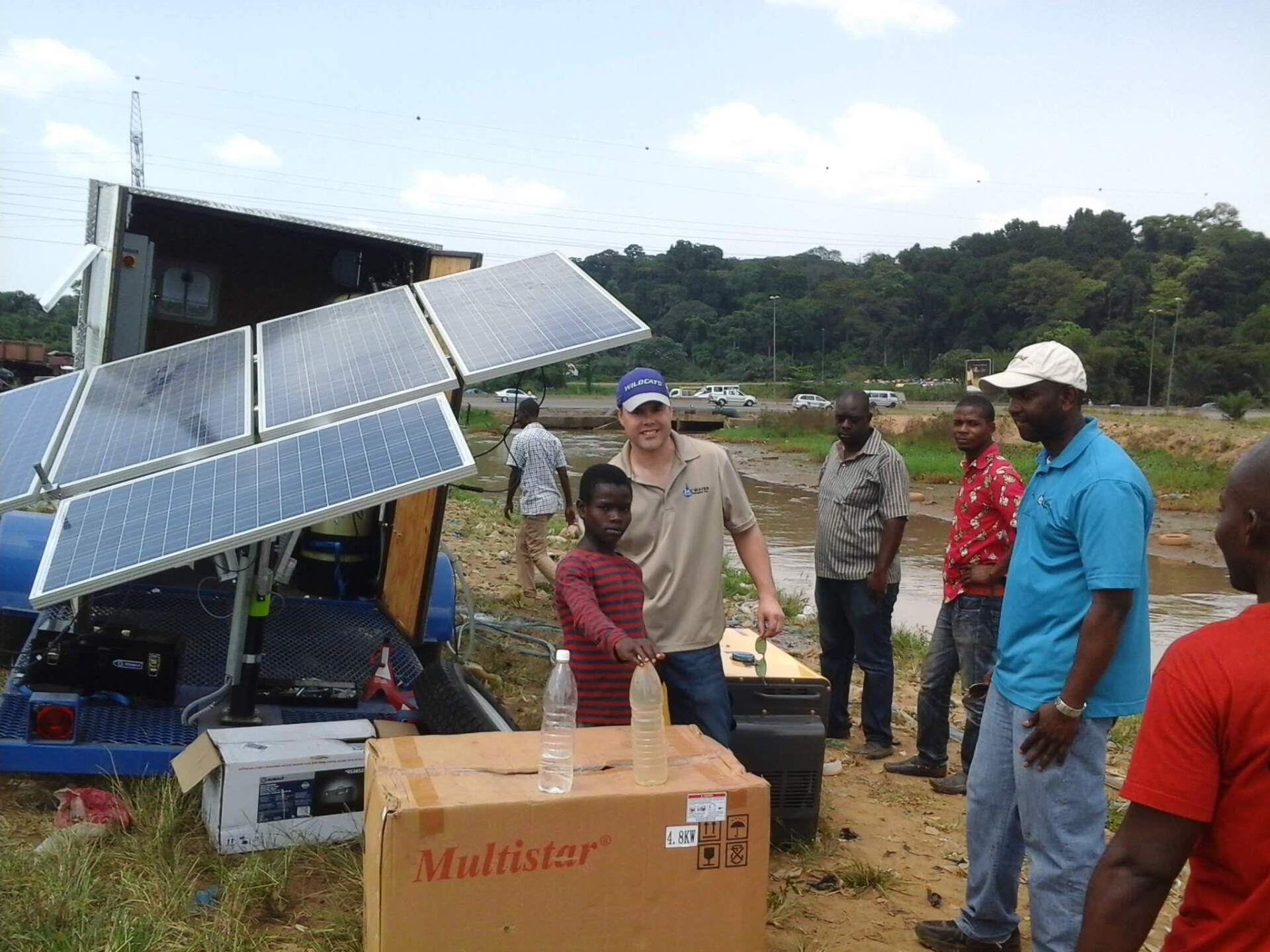 A group of people standing around a box that says multistar