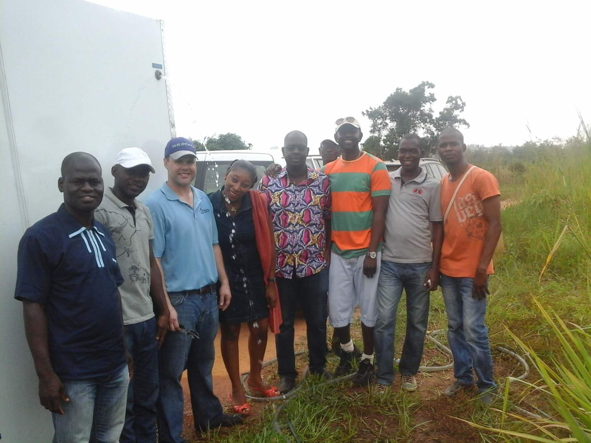 A group of people posing for a picture in a field