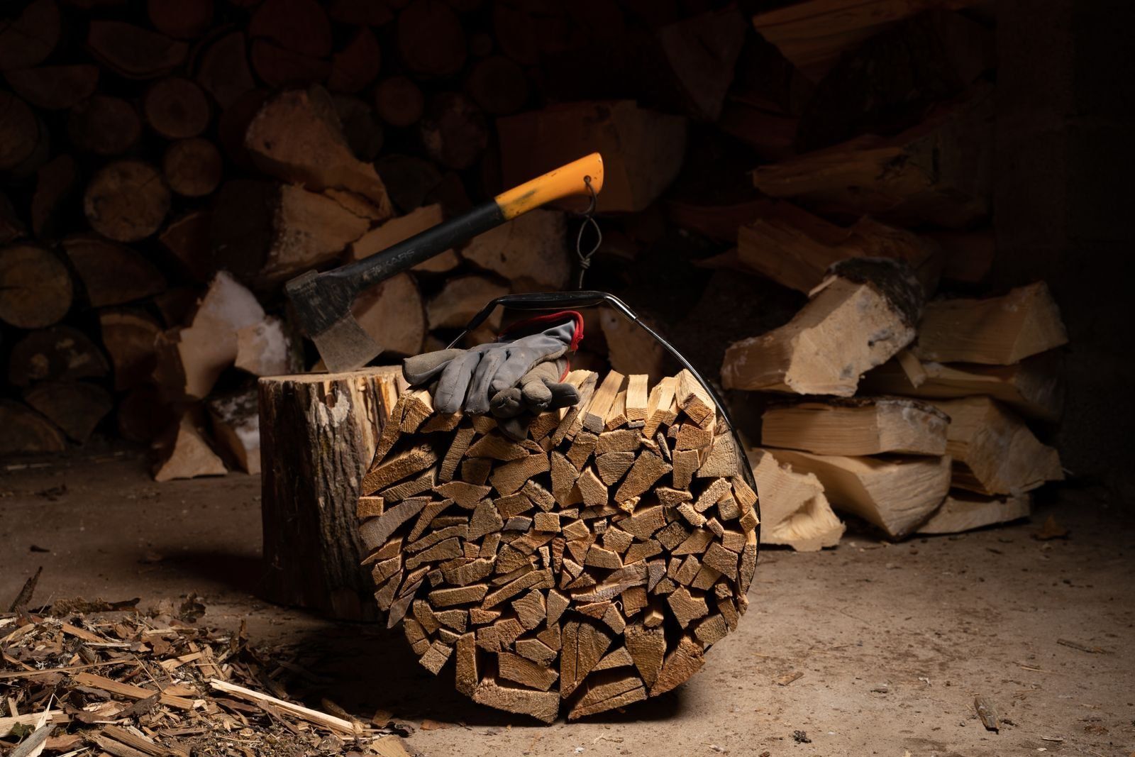 Firewood log carrier beside a woodshed