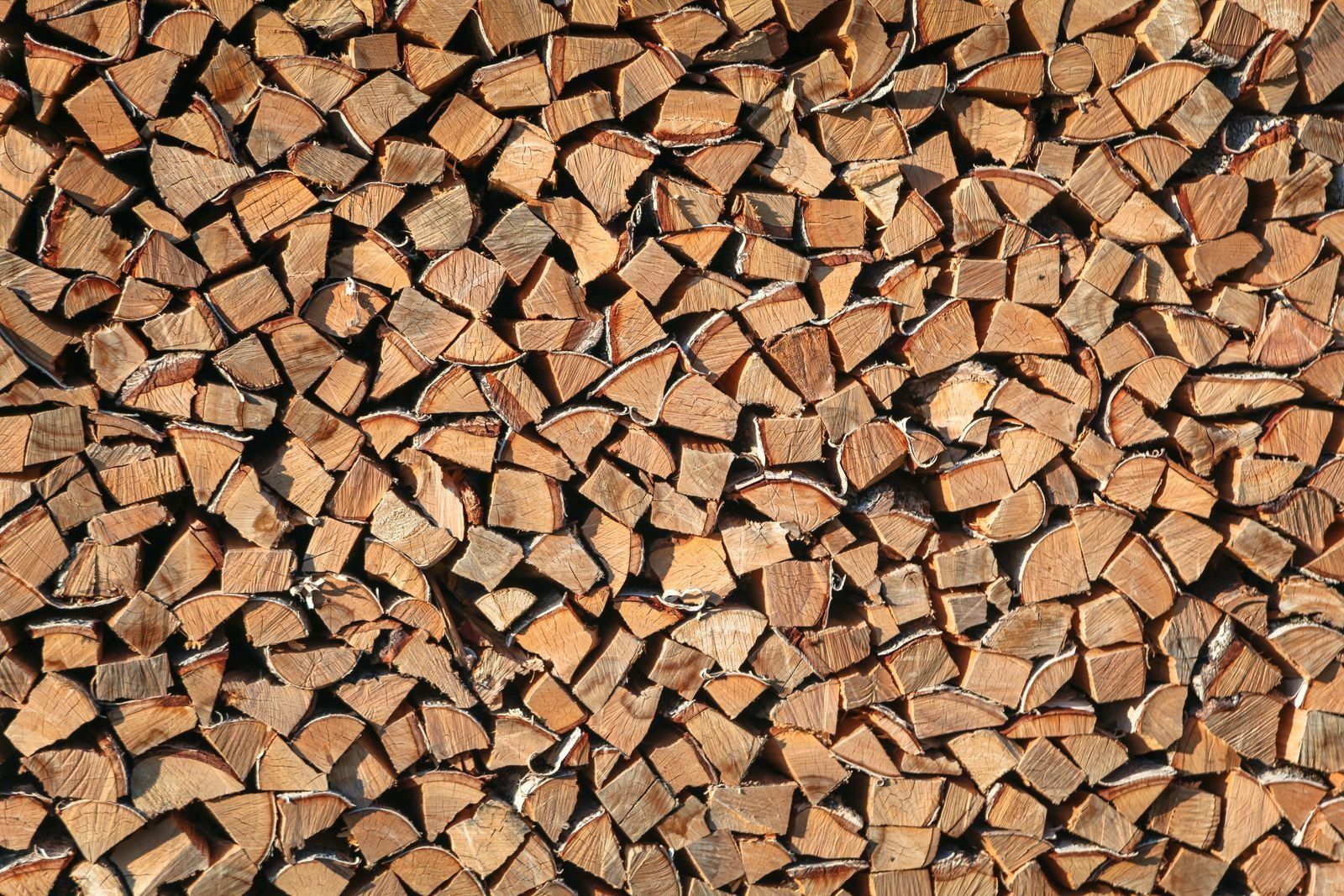 Firewood stacked in rows, sold by the cord