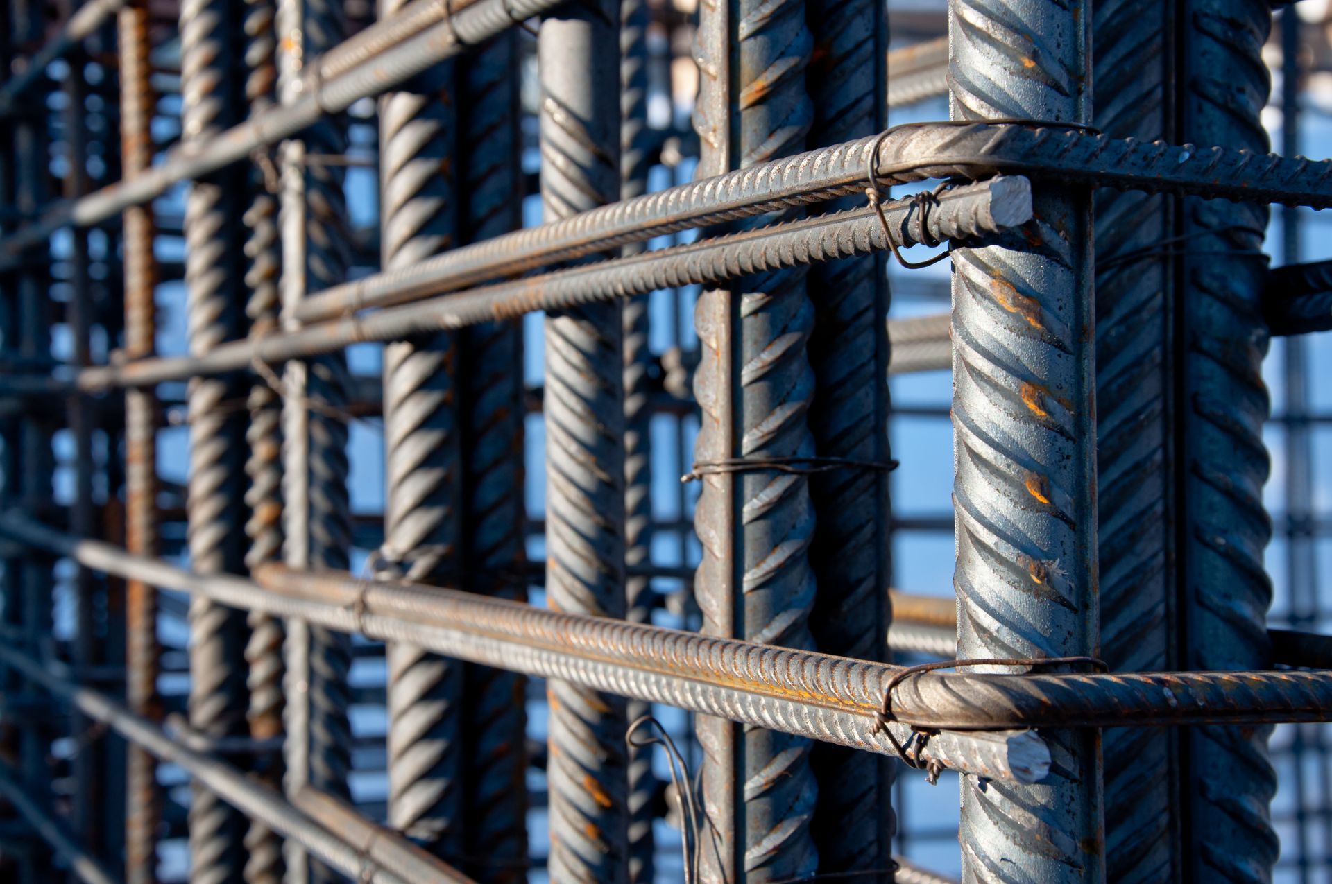 Close-up of tied steel rebar grid forming a reinforced concrete cage.