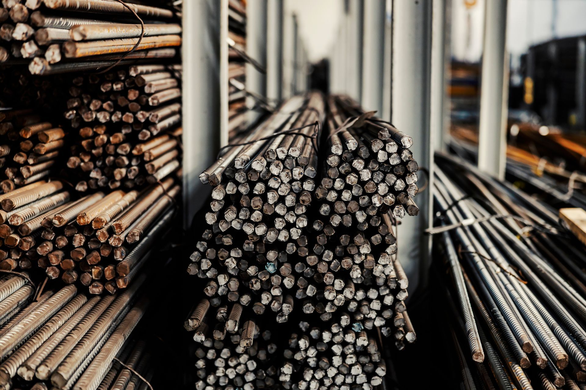 Stacked steel I-beams arranged in a neat pile, showcasing smooth metallic surfaces. Stacked steel I-beams arranged in a neat pile, showcasing smooth metallic surfaces.