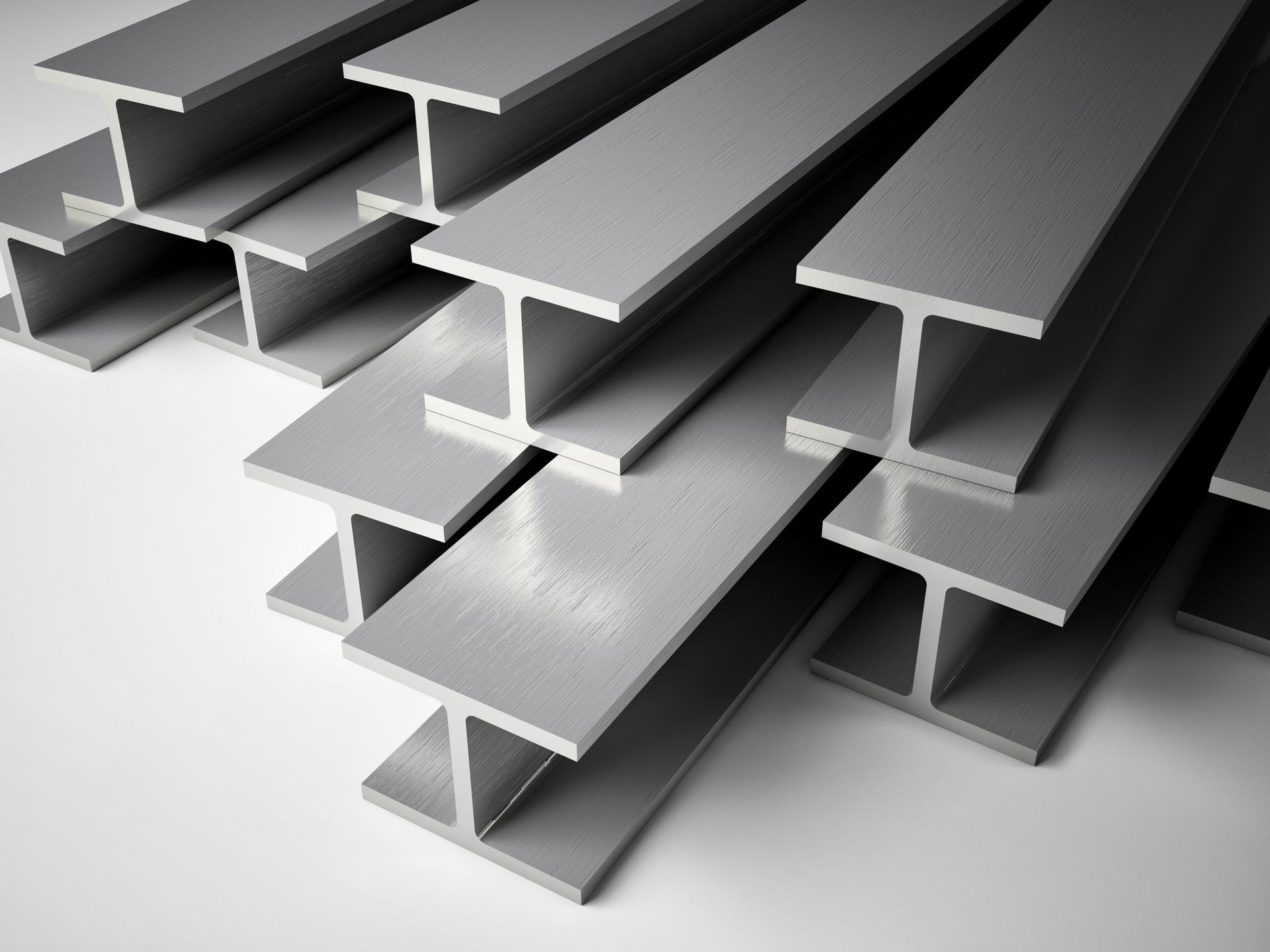 Stacked steel I-beams arranged in a neat pile, showcasing smooth metallic surfaces. Stacked steel I-beams arranged in a neat pile, showcasing smooth metallic surfaces.