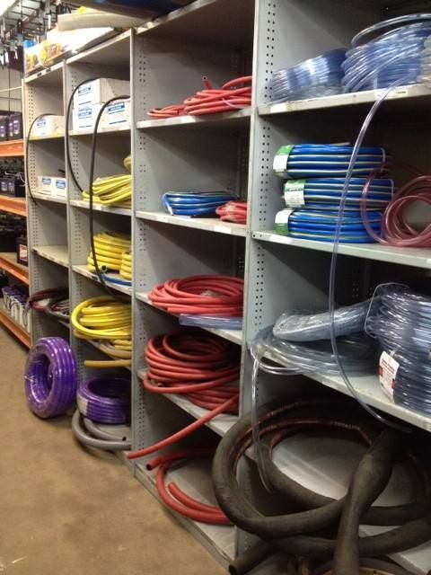 Metal Shelving Units Filled With Various Rolls of Colorful Plastic Tubing and Hoses — Ingham Agencies in Ingham, QLD