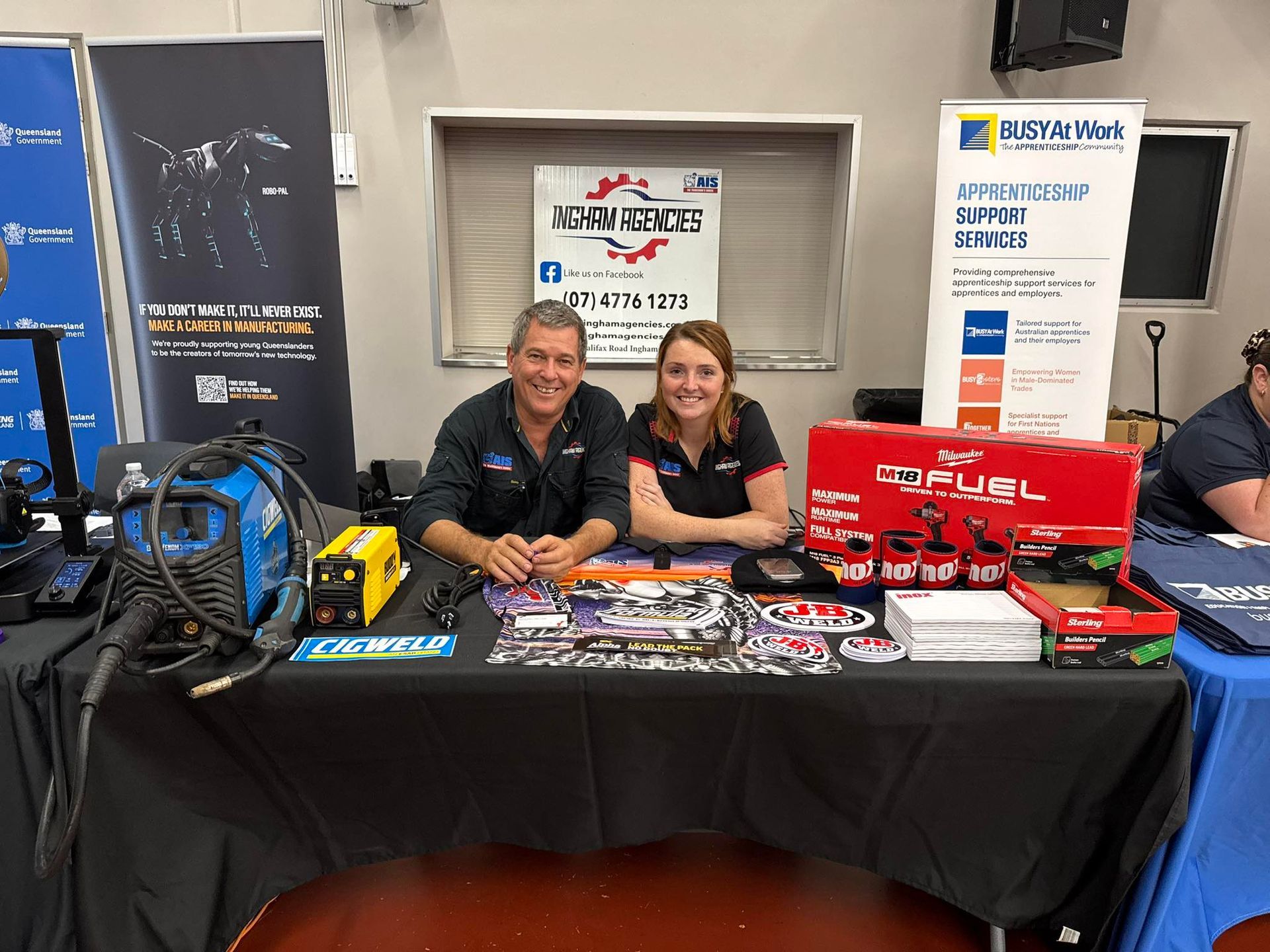 Two people sit at a trade show booth — Ingham Agencies in Ingham, QLD