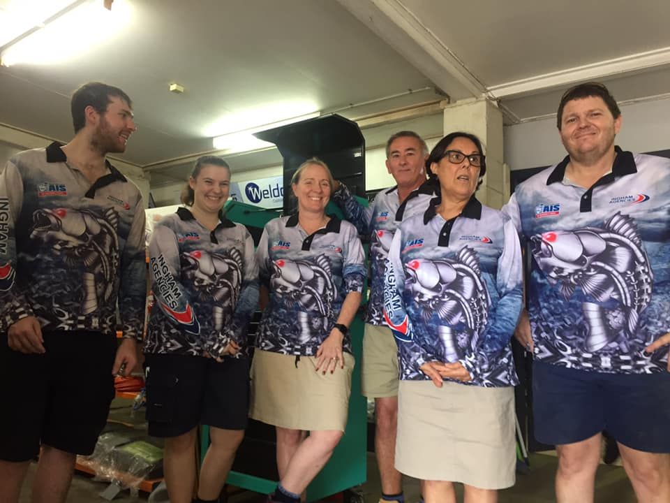 Five People Stand in a Line Indoors — Ingham Agencies in Ingham, QLD