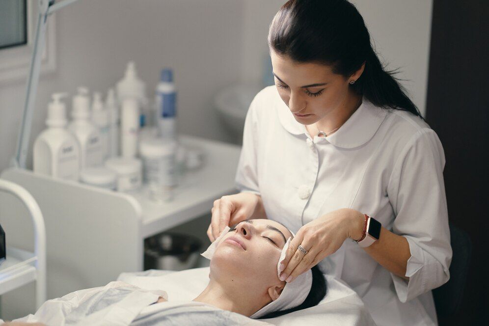 A woman is getting a facial treatment at a beauty salon.