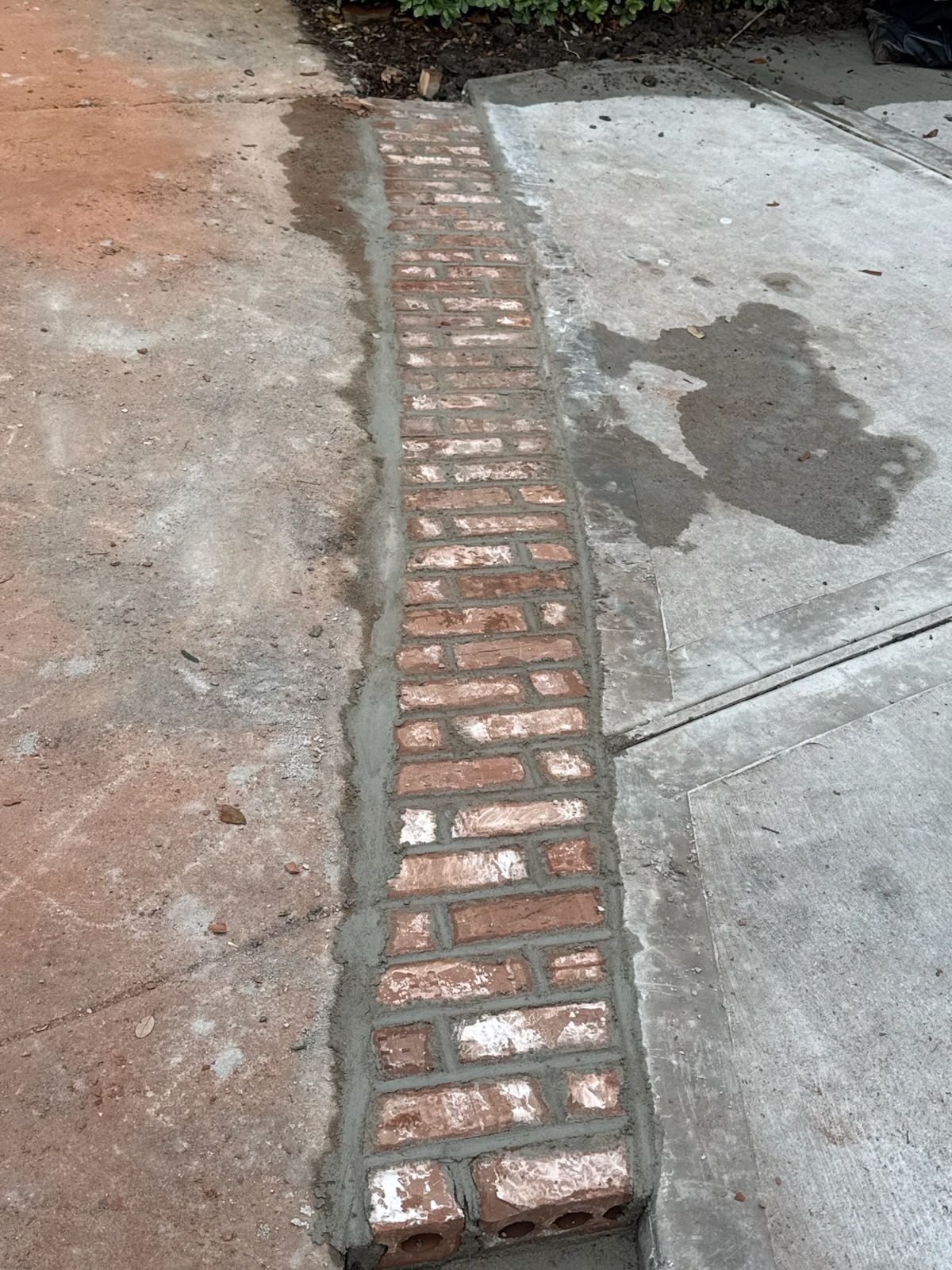 Cracked concrete driveway before repair